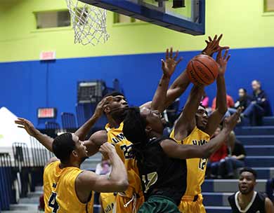 Photo CCAA: Lakeland Rustlers&rsquo; Paul Smith-Profit caught in some traffic under hoop against Humber Hawks